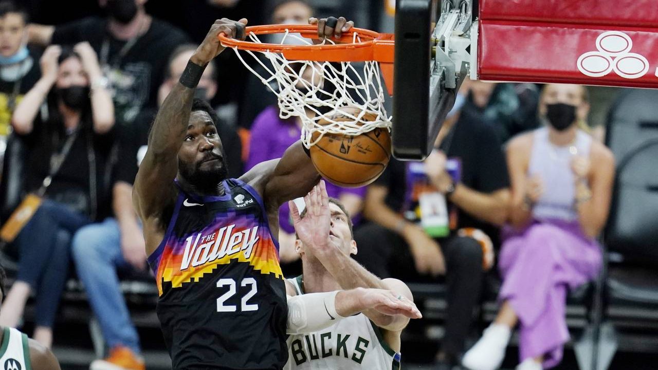 Phoenix Suns center Deandre Ayton (22) dunks against Milwaukee Bucks center Brook Lopez (11) during...