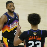 Phoenix Suns forward Mikal Bridges, left, celebrates with forward Cameron Johnson (23) during the second half of Game 2 of basketball's NBA Finals against the Milwaukee Bucks, Thursday, July 8, 2021, in Phoenix. (AP Photo/Ross D. Franklin)