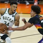 Milwaukee Bucks forward Giannis Antetokounmpo (34) drives against Phoenix Suns forward Cameron Johnson (23) during the first half of Game 2 of basketball's NBA Finals, Thursday, July 8, 2021, in Phoenix. (AP Photo/Ross D. Franklin)