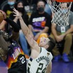 Phoenix Suns center Deandre Ayton (22) shoots over Milwaukee Bucks guard Pat Connaughton (24) during the second half of Game 1 of basketball's NBA Finals, Tuesday, July 6, 2021, in Phoenix. The Suns defeated the Bucks 118-105. (AP Photo/Ross D. Franklin)