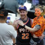 Phoenix Suns fans pose for a selfie prior to game 1 of basketball's NBA Finals against the Milwaukee Bucks, Tuesday, July 6, 2021, in Phoenix. (AP Photo/Ross D. Franklin)