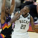 Milwaukee Bucks forward Khris Middleton (22) reacts after being fouled by Phoenix Suns guard Chris Paul, left, during the second half of Game 5 of basketball's NBA Finals, Saturday, July 17, 2021, in Phoenix. (AP Photo/Ross D. Franklin)