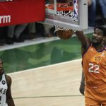 Phoenix Suns center Deandre Ayton dunks the ball ahead of Milwaukee Bucks forward Khris Middleton, left, during the first half of Game 4 of basketball's NBA Finals Wednesday, July 14, 2021, in Milwaukee. (AP Photo/Aaron Gash)
