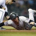 
              Colorado Rockies' Trevor Story, right, slides safely back to first base ahead of the tag by Arizona Diamondbacks' Christian Walker on a pickoff attempt during the sixth inning of a baseball game Tuesday, July 6, 2021, in Phoenix. (AP Photo/Ralph Freso)
            