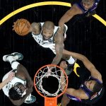 
              Milwaukee Bucks forward P.J. Tucker, center, shoots as Phoenix Suns forward Mikal Bridges, right looks on during the first half of Game 2 of basketball's NBA Finals, Thursday, July 8, 2021, in Phoenix. (AP Photo/Ross D. Franklin, pool)
            