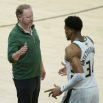 Milwaukee Bucks head coach Mike Budenholzer, left, greets forward Giannis Antetokounmpo during the second half of Game 2 of basketball's NBA Finals against the Phoenix Suns, Thursday, July 8, 2021, in Phoenix. (AP Photo/Ross D. Franklin)