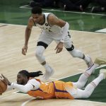 Phoenix Suns forward Jae Crowder fights for a loose ball with Milwaukee Bucks forward Giannis Antetokounmpo, top, during the first half of Game 4 of basketball's NBA Finals Wednesday, July 14, 2021, in Milwaukee. (AP Photo/Aaron Gash)