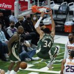 Milwaukee Bucks' Giannis Antetokounmpo (34) dunks during the first half of Game 3 of basketball's NBA Finals against the Phoenix Suns in Milwaukee, Sunday, July 11, 2021. (AP Photo/Paul Sancya)
