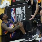
              Phoenix Suns forward Torrey Craig grabs his leg during the second half of Game 2 of basketball's NBA Finals against the Milwaukee Bucks, Thursday, July 8, 2021, in Phoenix. (AP Photo/Ross D. Franklin)
            