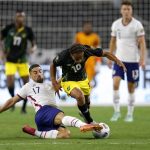 
              United States midfielder Sebastian Lletget (17) clears the ball away from Jamaica forward Bobby Reid (10) in the first half of a CONCACAF Gold Cup quarterfinals soccer match, Sunday, July 25, 2021, in Arlington, Texas. (AP Photo/Brandon Wade)
            