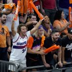 Phoenix Suns fans cheer on their team during the second half of Game 1 of basketball's NBA Finals against the Milwaukee Bucks, Tuesday, July 6, 2021, in Phoenix. The Suns defeated the Bucks 118-105. (AP Photo/Ross D. Franklin)