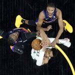 Milwaukee Bucks forward Giannis Antetokounmpo is fouled by Phoenix Suns forward Jae Crowder, left, as Phoenix Suns forward Mikal Bridges, right, defends during the first half of game 1 of basketball's NBA Finals, Tuesday, July 6, 2021, in Phoenix. (AP Photo/Matt York, Pool)