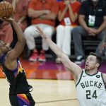 Phoenix Suns guard Chris Paul, left, shoots against Milwaukee Bucks guard Pat Connaughton (24) during the second half of Game 2 of basketball's NBA Finals, Thursday, July 8, 2021, in Phoenix. (AP Photo/Ross D. Franklin)