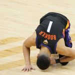 Phoenix Suns guard Devin Booker reacts after contact during the first half of Game 2 of basketball's NBA Finals against the Milwaukee Bucks, Thursday, July 8, 2021, in Phoenix. (AP Photo/Matt York)
