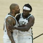 Milwaukee Bucks forward P.J. Tucker, left, celebrates with guard Jrue Holiday during the second half of Game 5 of basketball's NBA Finals against the Phoenix Suns, Saturday, July 17, 2021, in Phoenix. (AP Photo/Ross D. Franklin)