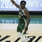 Milwaukee Bucks guard Jrue Holiday reacts after hitting a basket against the Phoenix Suns during the second half of Game 3 of basketball's NBA Finals in Milwaukee, Sunday, July 11, 2021. (AP Photo/Paul Sancya)