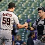Arizona Diamondbacks relief pitcher Brett de Geus, left, celebrates with catcher Daulton Varsho after the Diamondbacks defeated the Chicago Cubs 7-3 in a baseball game in Chicago, Saturday, July 24, 2021. (AP Photo/Nam Y. Huh)