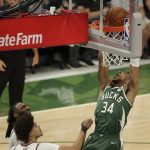 Milwaukee Bucks' Giannis Antetokounmpo (34) dunks during the second half of Game 3 of basketball's NBA Finals against the Phoenix Suns, Sunday, July 11, 2021, in Milwaukee. (AP Photo/Aaron Gash)