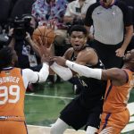 Milwaukee Bucks forward Giannis Antetokounmpo (34) is double teamed by Phoenix Suns forward Jae Crowder (99) and guard Chris Paul during the first half of Game 6 of basketball's NBA Finals Tuesday, July 20, 2021, in Milwaukee. (AP Photo/Aaron Gash)