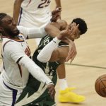 Milwaukee Bucks' Giannis Antetokounmpo, right, is fouled by Phoenix Suns' Jae Crowder, left, during the second half of Game 3 of basketball's NBA Finals, Sunday, July 11, 2021, in Milwaukee. (AP Photo/Aaron Gash)