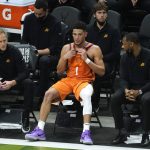 Phoenix Suns guard Devin Booker (1) sits on the bench during the second half against the Milwaukee Bucks in Game 4 of basketball's NBA Finals in Milwaukee, Wednesday, July 14, 2021. (AP Photo/Paul Sancya)