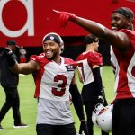 Cardinals S Budda Baker and LBs Chandler Jones and Isaiah Simmons point to the crowd during training camp Friday, July 30, 2021, in Glendale. (Tyler Drake/Arizona Sports)