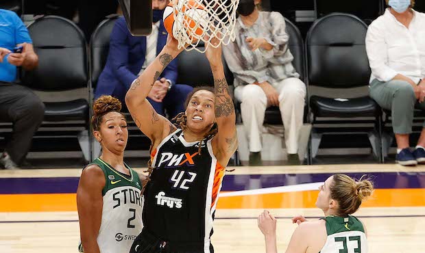 Brittney Griner #42 of the Phoenix Mercury puts up a shot over Mercedes Russell #2, Epiphanny Princ...