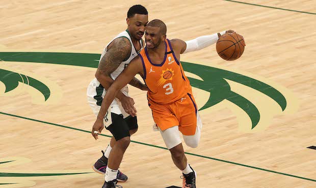 Chris Paul #3 of the Phoenix Suns drives past Jeff Teague #5 of the Milwaukee Bucks during the firs...