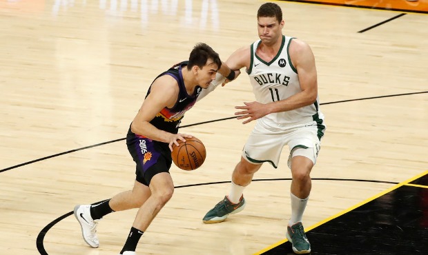Dario Saric #20 of the Phoenix Suns drives to the basket against Brook Lopez #11 of the Milwaukee B...