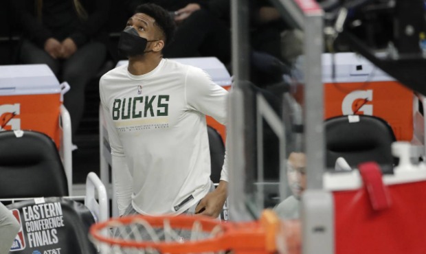 Milwaukee Bucks' Giannis Antetokounmpo looks up to the scoreboard from the bench during the second ...