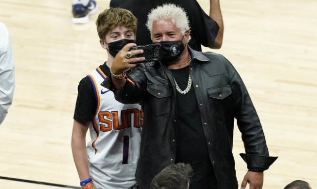 Television personality Guy Fieri, right, takes a selfie with his son, Hunter Fieri, prior to Game 1...