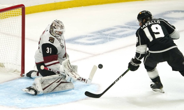 Los Angeles Kings right wing Alex Iafallo, right, tires to get a shot past Arizona Coyotes goaltend...
