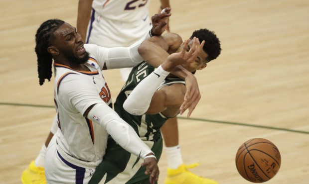 Milwaukee Bucks' Giannis Antetokounmpo, right, is fouled by Phoenix Suns' Jae Crowder, left, during...