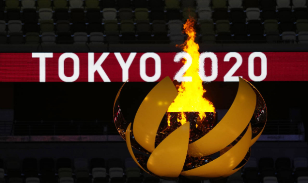 The Olympic flame burns during the opening ceremony in the Olympic Stadium at the 2020 Summer Olymp...