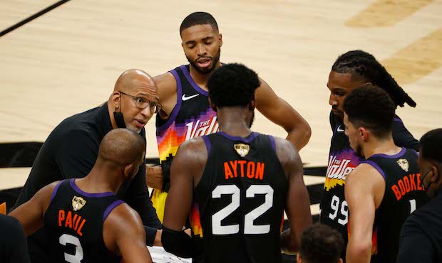 Head coach Monty Williams of the Phoenix Suns huddles his team during a time out against the Milwau...