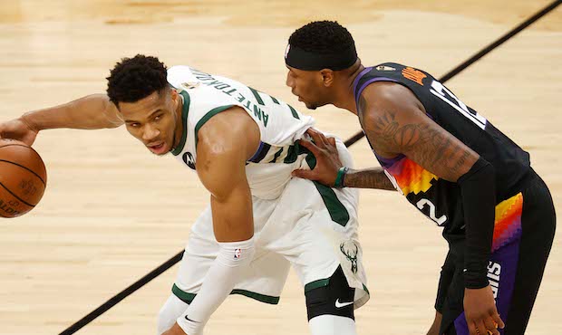 Giannis Antetokounmpo #34 of the Milwaukee Bucks is defended by Torrey Craig #12 of the Phoenix Sun...