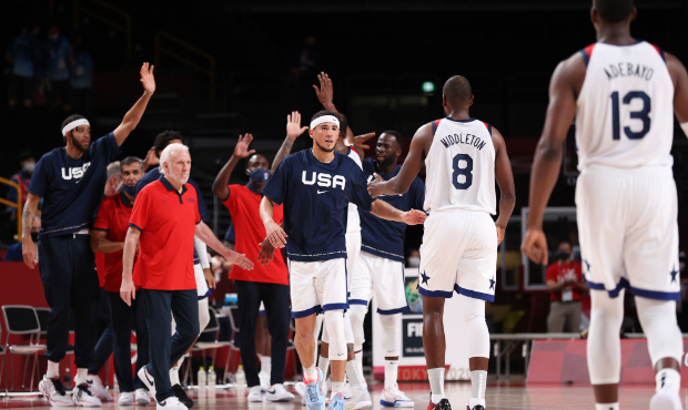 Devin Booker #15 of Team United States congratulates his teammates following their vicory over the ...