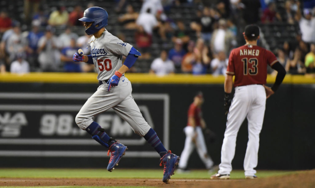 Mookie Betts #50 of the Los Angeles Dodgers rounds the bases after hitting a solo home run off Brya...
