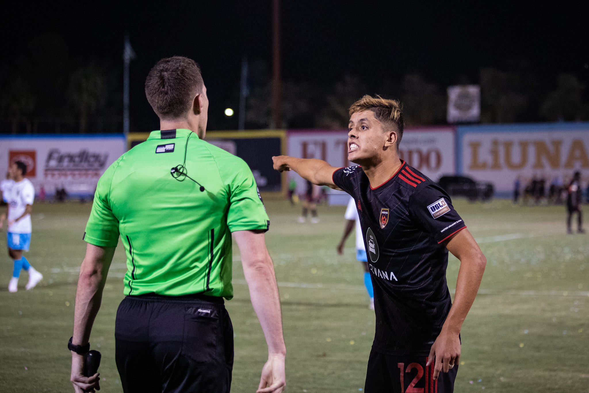 Phoenix Rising midfielder Arturo Rodriguez speaks with the assistant referee during a 2-2 draw away...