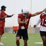 Cardinals WR Andy Isabella stiff arms WR Christian Kirk during practice Monday, Aug. 30, 2021, in Tempe. (Tyler Drake/Arizona Sports)