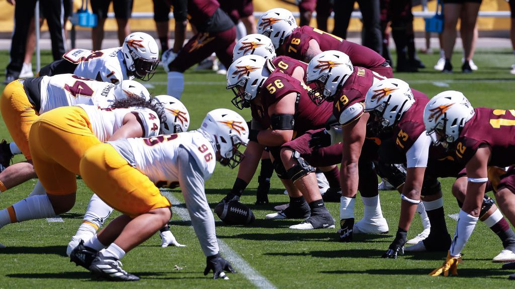 The Arizona State Sun Devils offense and defense line up during the college football spring scrimma...