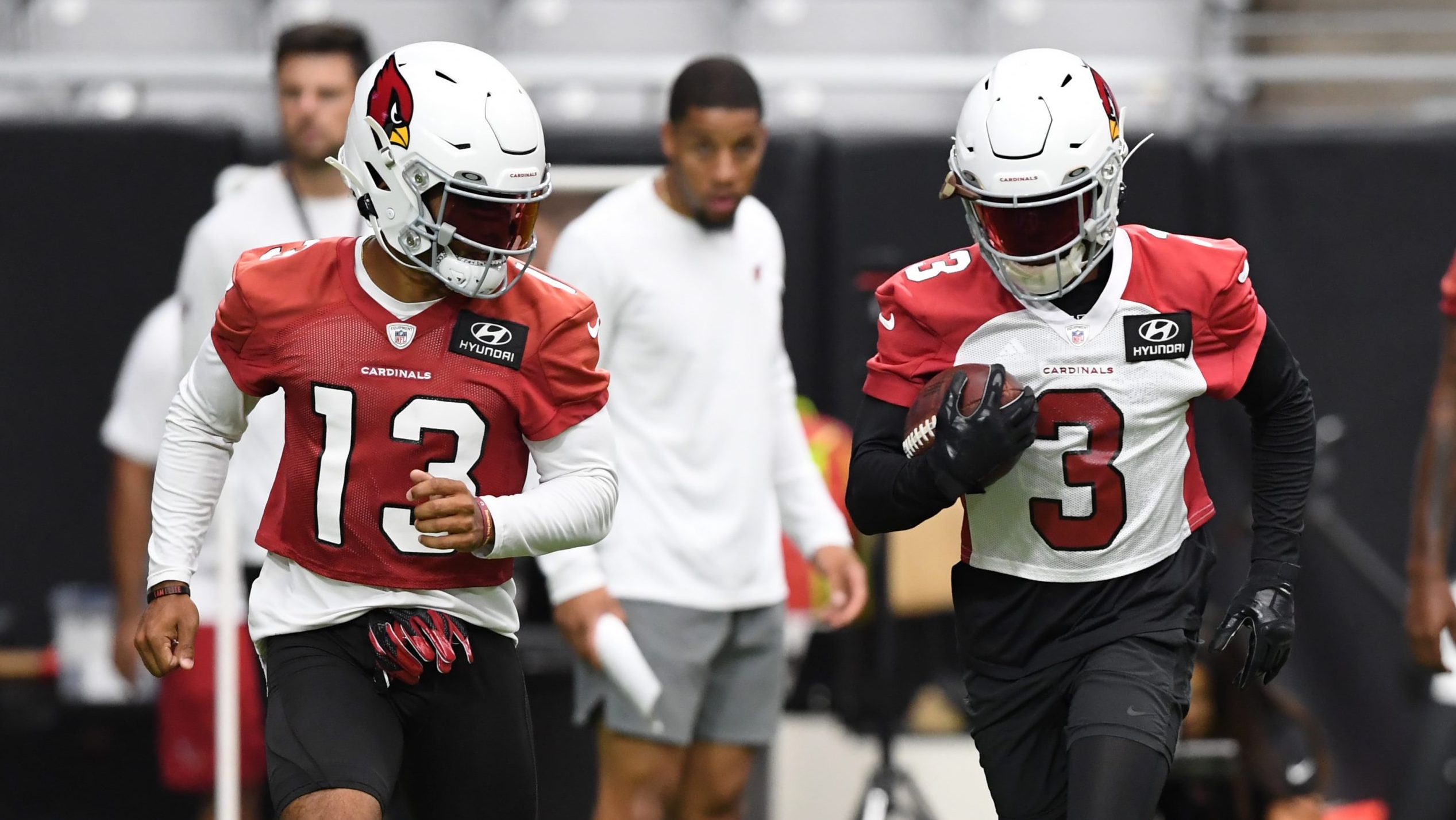 Budda Baker #3 and Christian Kirk #13 of the Arizona Cardinals participate in drills during Trainin...