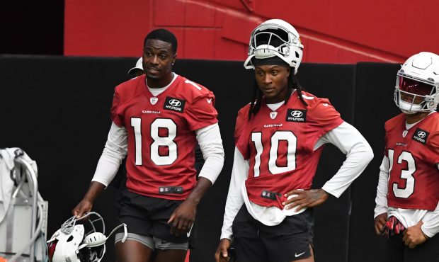 DeAndre Hopkins #10 and A.J. Green #18 of the Arizona Cardinals look on during passing drills at Tr...