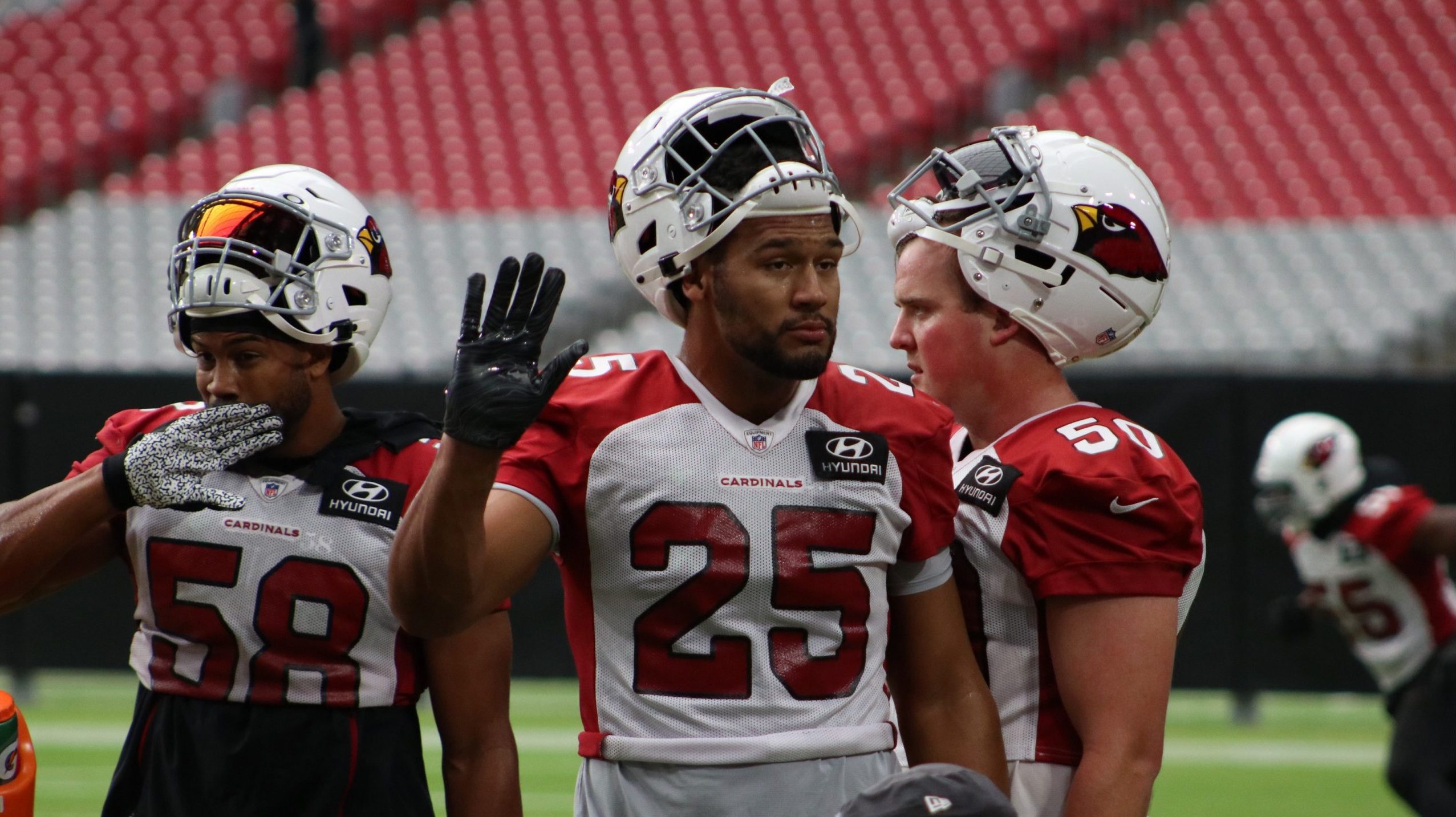 Cardinals rookie LB Zaven Collins waves to the crowd during training camp on Sunday, Aug. 15, in Gl...