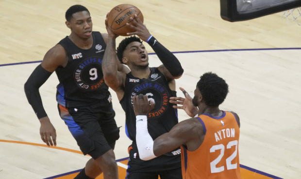 New York Knicks guard Elfrid Payton (6) shoots over Phoenix Suns center Deandre Ayton (22) during t...