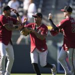 From left, Arizona Diamondbacks left fielder David Peralta celebrates with center fielder Ketel Marte and right fielder Pavin Smith after the ninth inning of a baseball game against the Colorado Rockies, Sunday, Aug. 22, 2021, in Denver. (AP Photo/David Zalubowski)