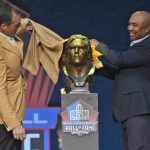 Alan Faneca, a member of the Pro Football Hall of Fame Class of 2021, left, and his presenter Hines Ward unveil the bust during the induction ceremony at the Pro Football Hall of Fame, Sunday, Aug. 8, 2021, in Canton, Ohio. (AP Photo/David Richard)