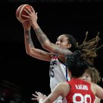 United States's Brittney Griner (15) drives over Japan's Himawari Akaho (88) during women's basketball gold medal game at the 2020 Summer Olympics, Sunday, Aug. 8, 2021, in Saitama, Japan. (AP Photo/Charlie Neibergall)