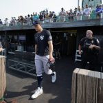 New York Yankees right fielder Aaron Judge walks to the field for warm ups before a baseball game against the Chicago White Sox, Thursday, Aug. 12, 2021 in Dyersville, Iowa. The Yankees and White Sox are playing at a temporary stadium in the middle of a cornfield at the Field of Dreams movie site, the first Major League Baseball game held in Iowa. (AP Photo/Charlie Neibergall)