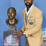 Charles Woodson, a member of the Pro Football Hall of Fame Class of 2021, poses with his bust during the induction ceremony at the Pro Football Hall of Fame, Sunday, Aug. 8, 2021, in Canton, Ohio. (AP Photo/Ron Schwane, Pool)